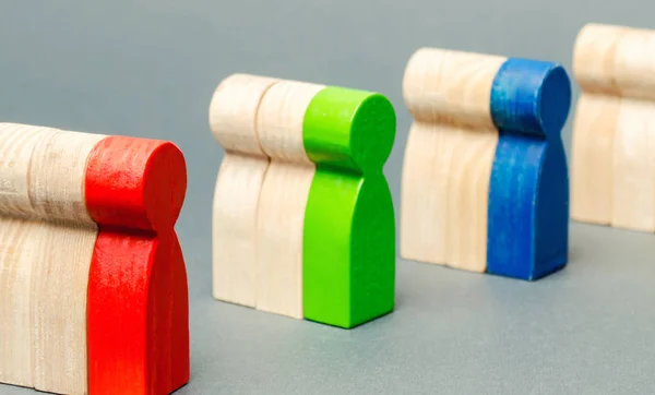 Groups of multicolored wooden people. The concept of market segmentation. Target audience, customer care. Market group of buyers. Customer relationship management. Selective focus