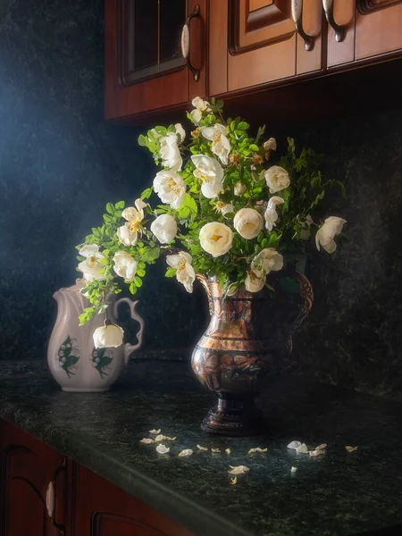 Still life with bouquet of wild roses on the kitchen