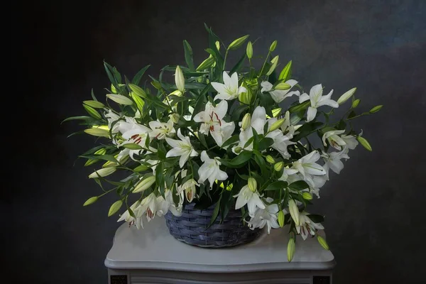 Still life with white lily bouquet in basket