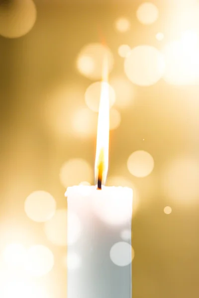 Bir ışık mum bokeh arka planda parlakça yanıyor.