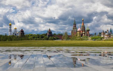 View from the hill of the Zaryadye park on church Ivan the Great Bell Tower and reflections. Cloudy weather with thunderclouds on a background clipart
