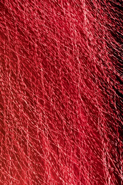 Texture from the red lines   from bright night firestwirled in a circle against a dark background. Motion blur