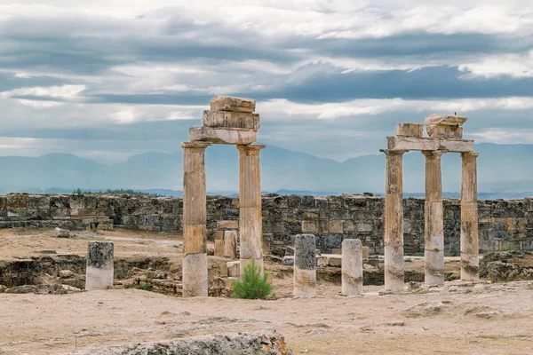 The ancient destroyed city of Hierapolis near Pamukkale, Denizli, Turkey in the summer. On a background the sky in overcast. Horizontal frame