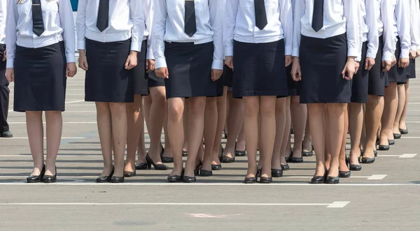 Female regiment in black skirts and white shirts keep a system — Stock Photo, Image