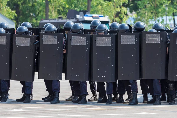 Dense system of police with metal armored boards before soldiers