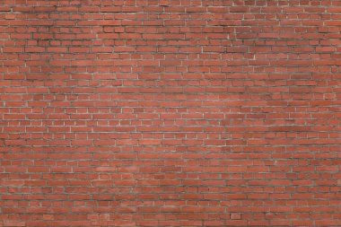 Arka plan kırmızı ve kahverengi tuğlalardan yapılmıştır. Yıpranmış yüzey dokusu. bulutlu ışıklandırma