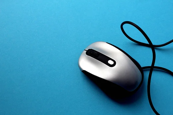 computer mouse with wire on a blue background