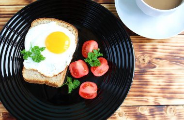 Sahanda yumurta bir plaka ile siyah ekmek üzerinde