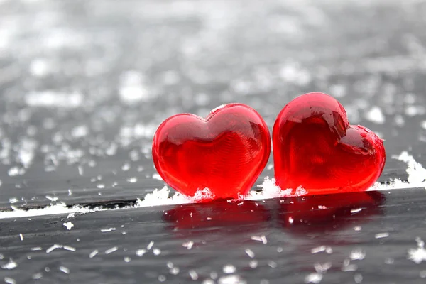 Two Red Plastic Hearts Black Background Studded White Snowflakes — Stock Photo, Image