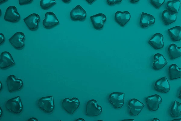 Texture of turquoise hearts on a turquoise background