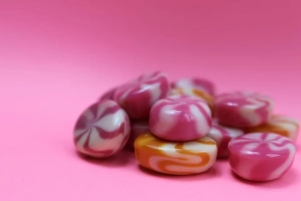 Texture sweet candy caramel on a pink background