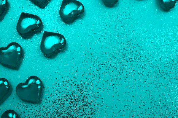 Texture of turquoise hearts on a turquoise background