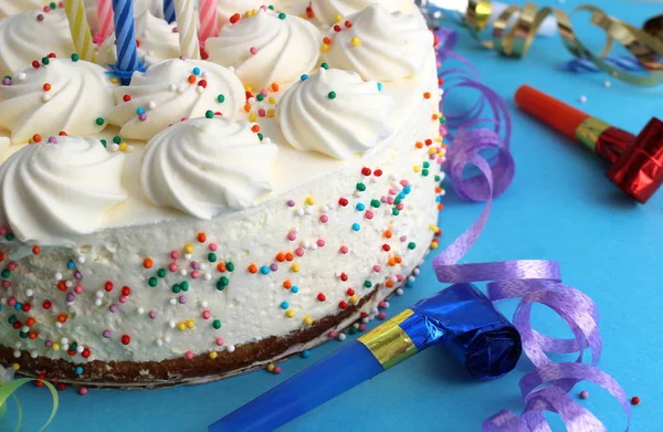 Birthday cake with candles for birthday on a blue background with confetti