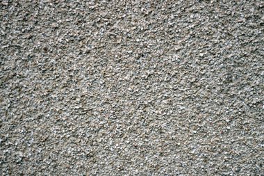 Çok küçük çakıl taşlarından oluşan taş bir duvarın dokusu. Bir taş duvarın parçası, arkaplan veya doku için.