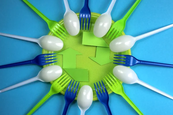 Plastic contamination. Anti fast food movement. Environmental Protection. Disposable forks and spoons around the plate