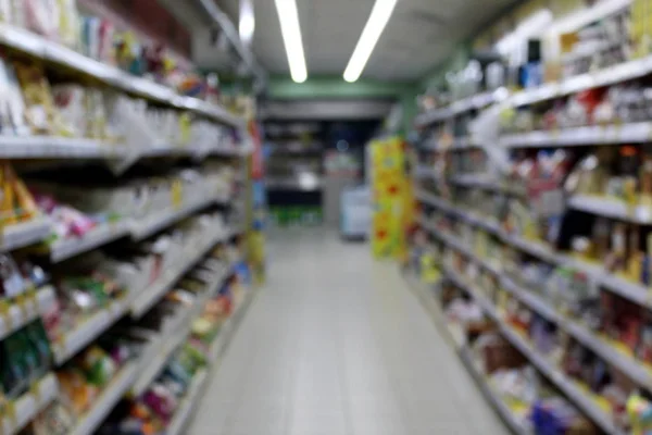 Blurred photo of consumer goods in a supermarket grocery store.