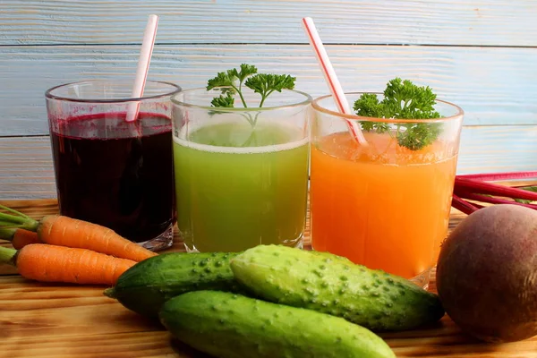 three types of vegetable juices on the table