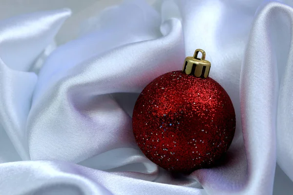 Red Shiny Christmas Toy Lies White Cloth — Stock Photo, Image