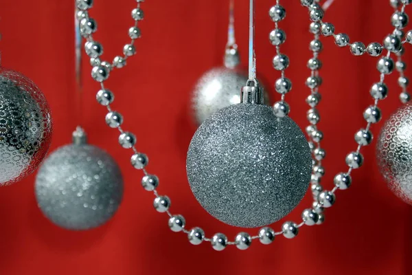 Silver Christmas Toys Garland Beads Balls Hang Red Background — Stock Photo, Image
