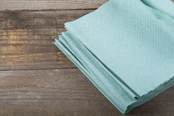 Multi-colored kitchen napkins on a dark wooden background