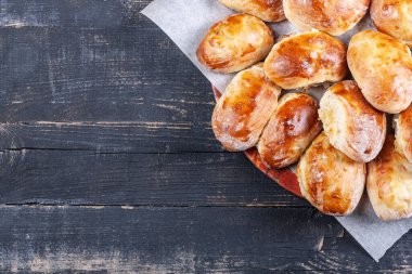 Koyu ahşap arka planda lahanalı bir sürü ev yapımı turta.