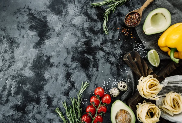beautiful layout of vegetables and products top view on a gray dark concrete background