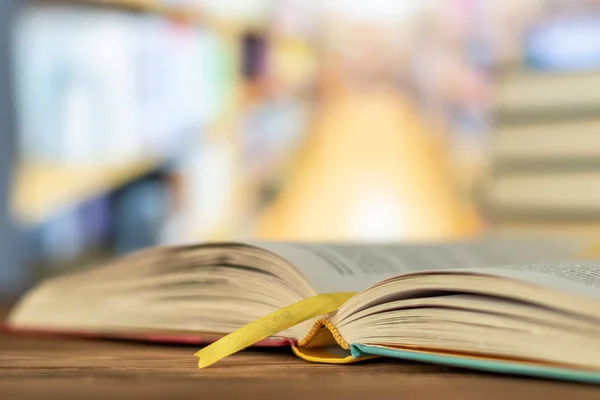 Education learning concept with opening book or textbook in old library, stack piles of literature text