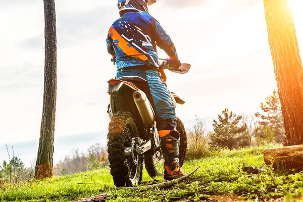 Man riding a motocross in a protective suit in the mud — Stock Photo, Image