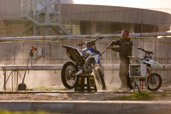 Bike rider washing his motorcycle