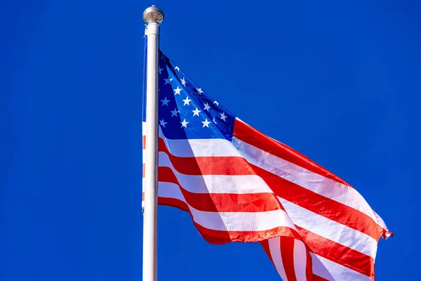 Bandera americana contra el cielo azul . — Foto de Stock