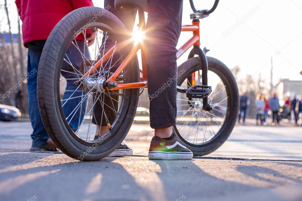 Urban biking - teenage boy riding bike in city
