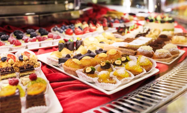 Tasty beautiful cakes on a show-window in cafe. Stock Photo