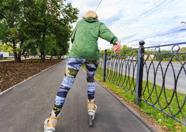 Young woman on roller skates in the park