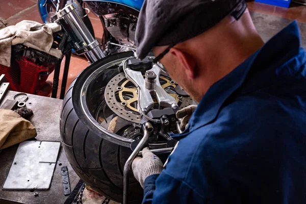 man repairing motorcycle tire with repair kit, Tire plug repair kit for tubeless tires.