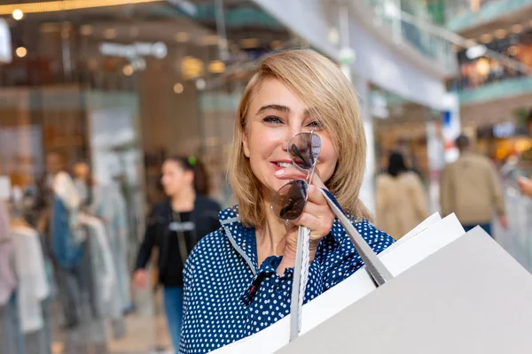 Fashion Shopping Girl Portrait. Beauty Woman with Shopping Bags in Shopping Mall. Shopper. Sales.