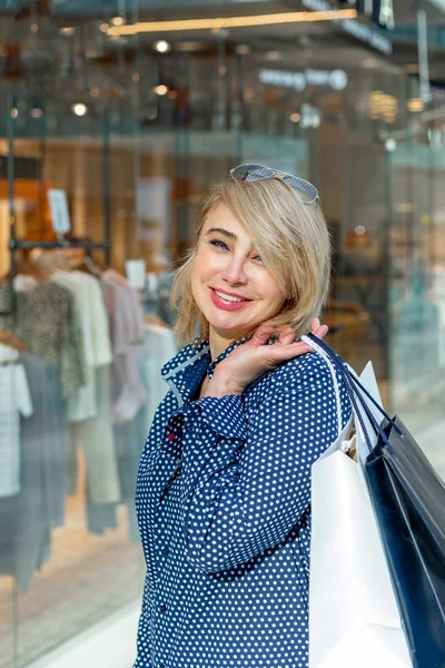 Fashion Shopping Girl Portrait. Beauty Woman with Shopping Bags in Shopping Mall. Shopper. Sales.