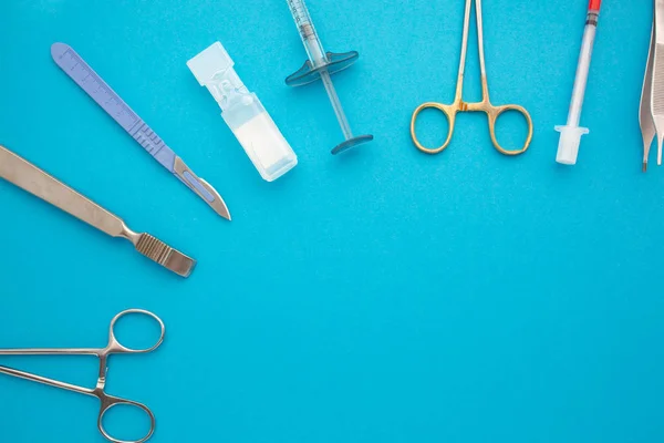 Flat lay of medical instruments on blue background