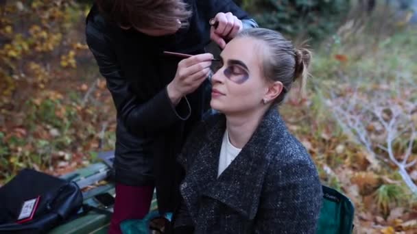 Make-up artist and stylist doing makeup model for Halloween. — Stock Video