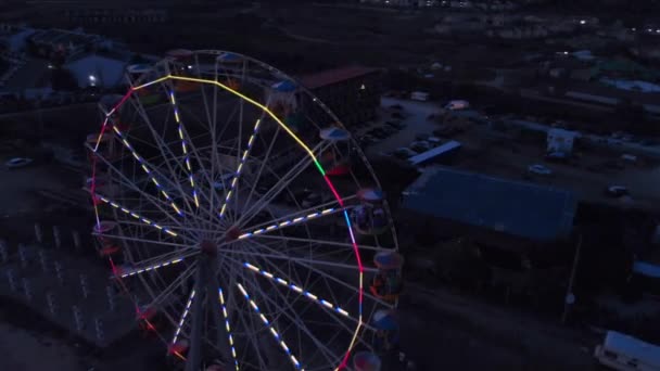 Ferris Wheel on the Background of the Sea at sunset. View from above — Stock Video