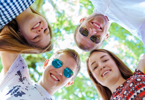 Teenagers standing in circle looking down at camera — Stock Photo, Image