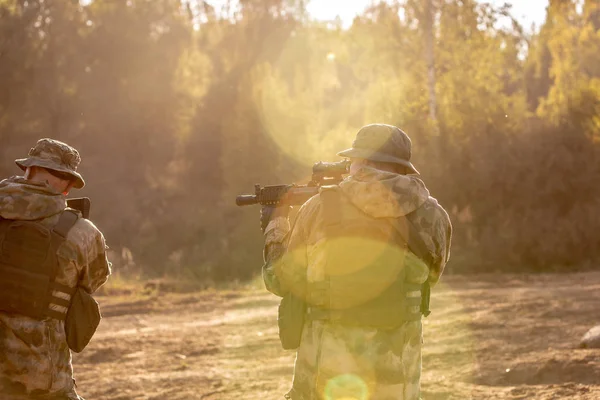 Sniper team armed with large caliber, sniper rifle, shooting enemy targets on range from shelter, sitting in ambush — Stock Photo, Image