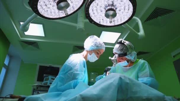 The surgeon is performing an operation on the eyes, close-up. Correction of. The doctor does blepharoplasty. Operation in the operating room. — Stock Video