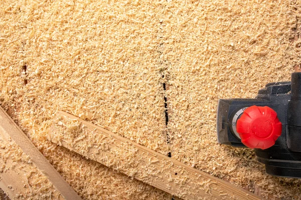 De elektrische sander op een houten backgroundshavings Stockafbeelding