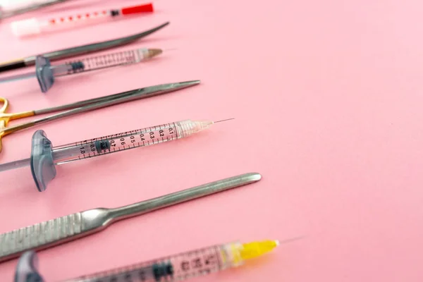 Плоская укладка медицинских инструментов на розовом фоне. Образец медицинского образования . — стоковое фото