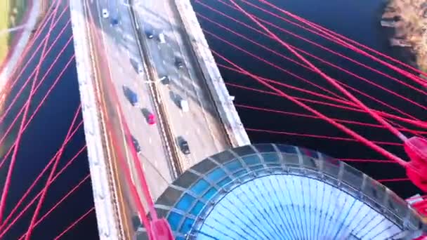 Aerial view of the iconic landmark that is Picturesque Bridge which crosses the Moscow River in Moscow. Close-up view of upper structures of cable-stayed bridge of red color at day time. 4K. — Stock Video