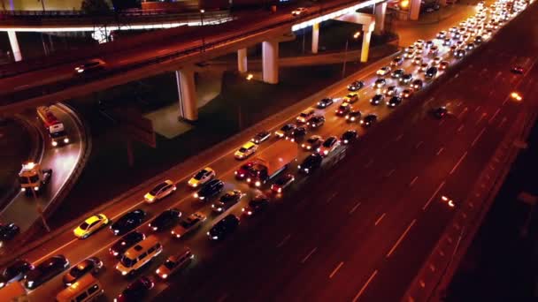 4K. Vista aérea do intercâmbio rodoviário com tráfego urbano movimentado que acelera na estrada à noite. Rede de transporte de junção . — Vídeo de Stock