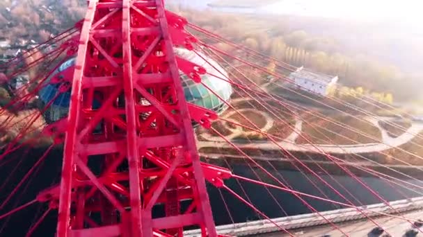 Aerial view of the iconic landmark that is Picturesque Bridge which crosses the Moscow River in Moscow. Cars traffic on cable-stayed bridge of red color at day time. 4K. — Stock Video