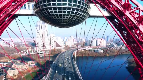 Vue aérienne du monument emblématique qu'est le Pont pittoresque qui traverse la rivière Moscou à Moscou. Trafic de voitures sur le pont à haubans de couleur rouge le jour. 4K . — Video