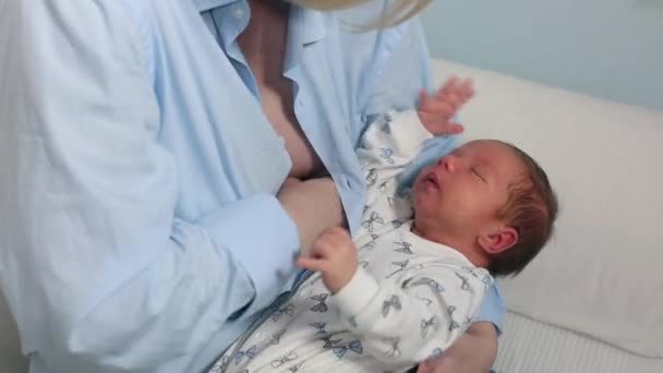 Mother breast feeding and hugging her 