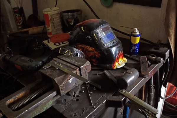 Защитные шлемы и гаечные ключи на столе в мастерской. Промышленная сцена с оборудованием — стоковое фото
